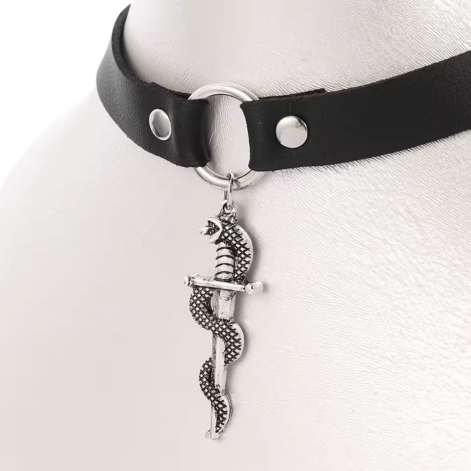 Black leather choker with a silver snake and dagger pendant on a mannequin.