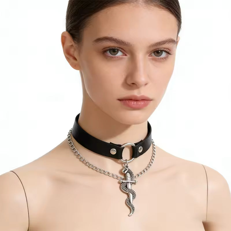 Woman wearing a black choker with a silver snake pendant on a white background